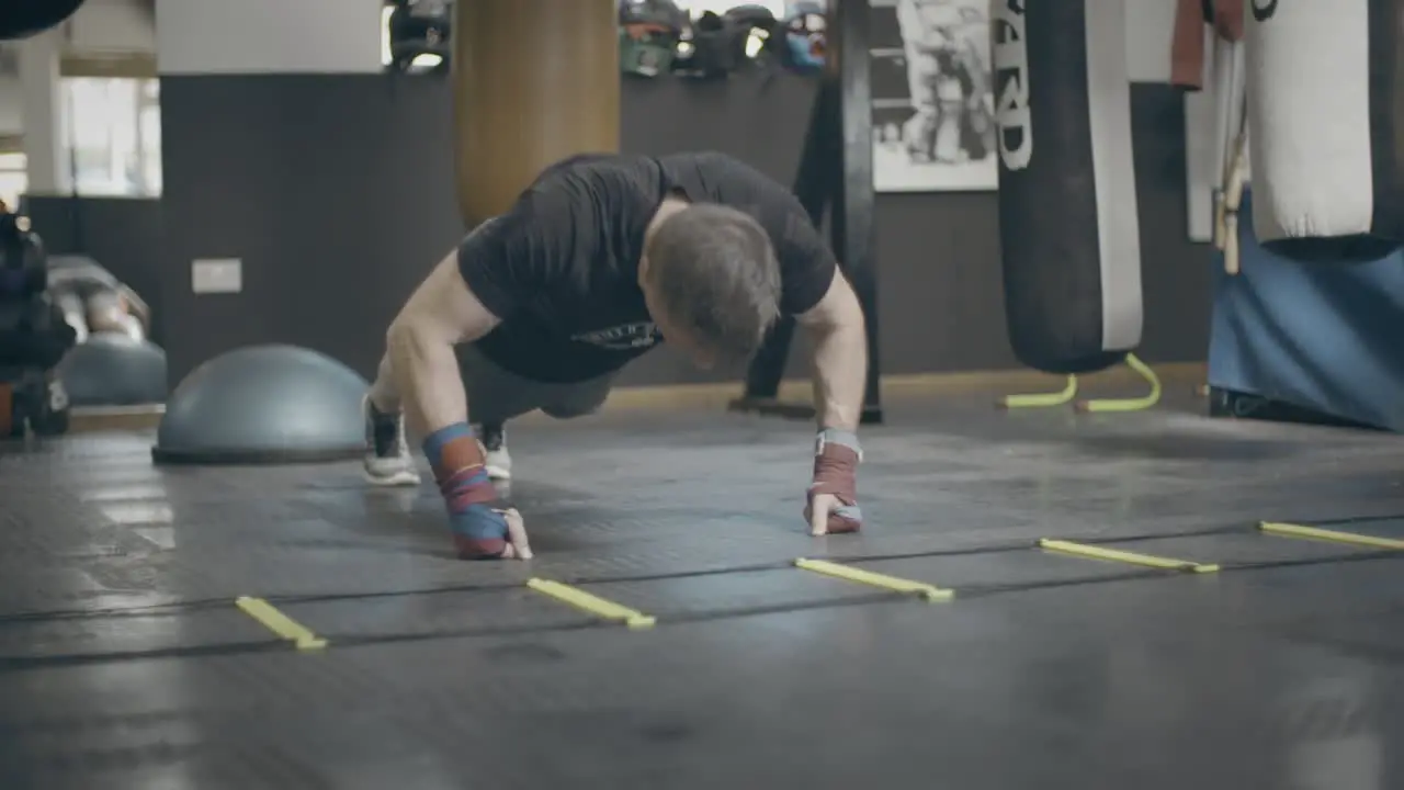 Man Doing Press Ups in Boxing Gym