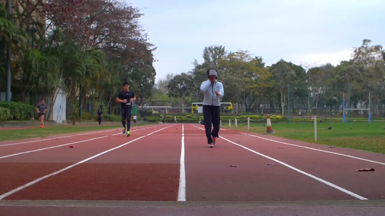 Low Level Shot of Runners on a Track