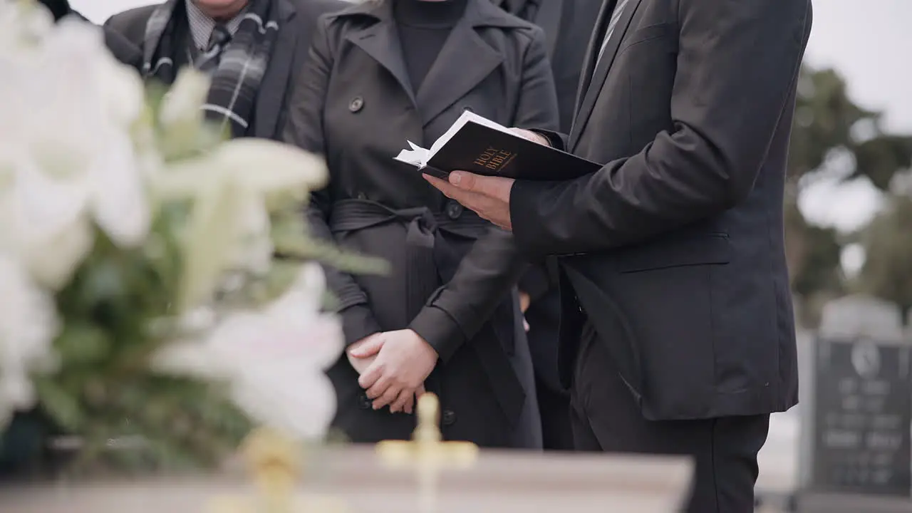 Bible hands and family at funeral