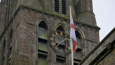 Low Angle Shot Looking Up at England Flag On Church Mast 