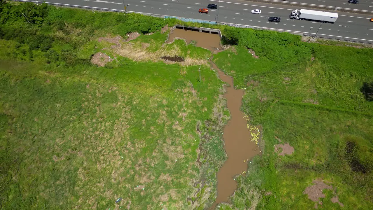 Aerial over Mudgeeraba creek parkland and M1 Gold Coast Queensland Australia