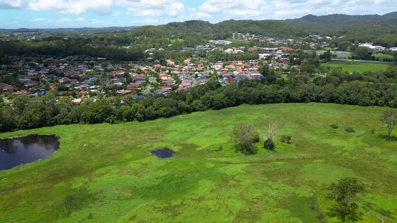 Aerial over Mudgeeraba housing and Firth Park Gold Coast Queensland Australia