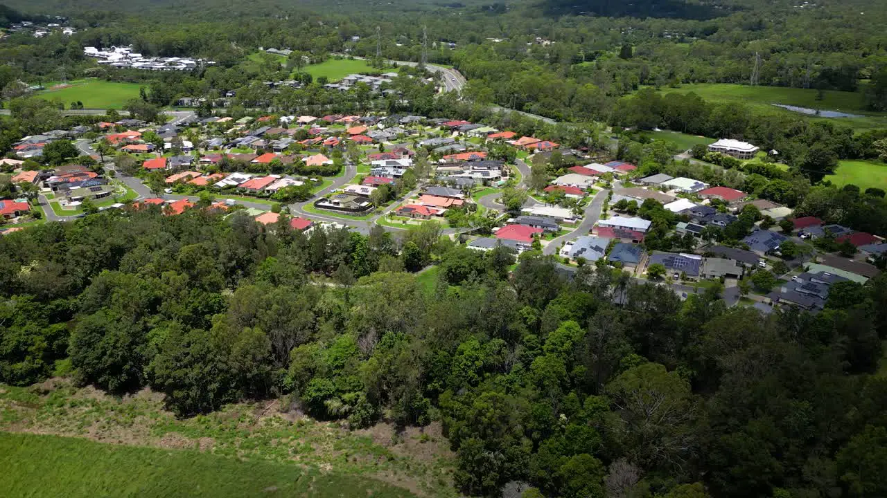 Right to left aerial over residential housing Mudgeeraba Gold Coast Queensland Australia