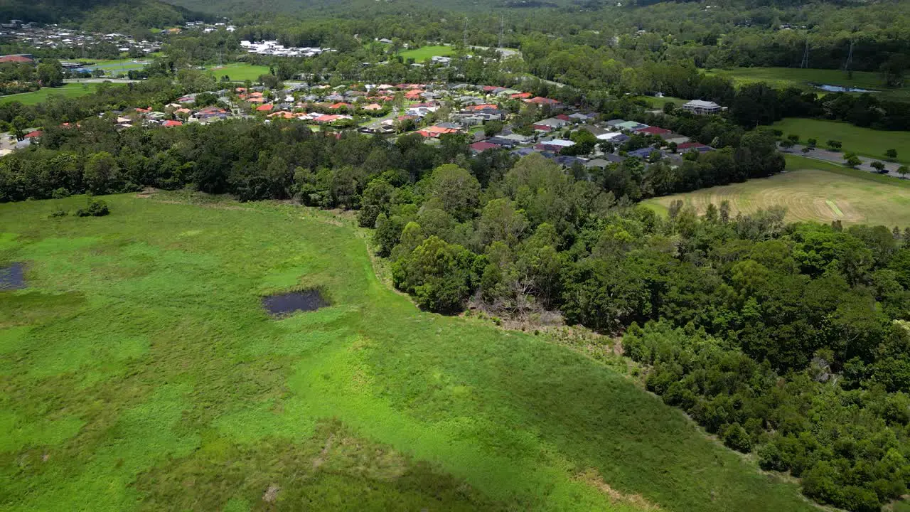 Aerial over Mudgeeraba Creek Firth Park and residential housing in Mudgeeraba Gold Coast Queensland Australia