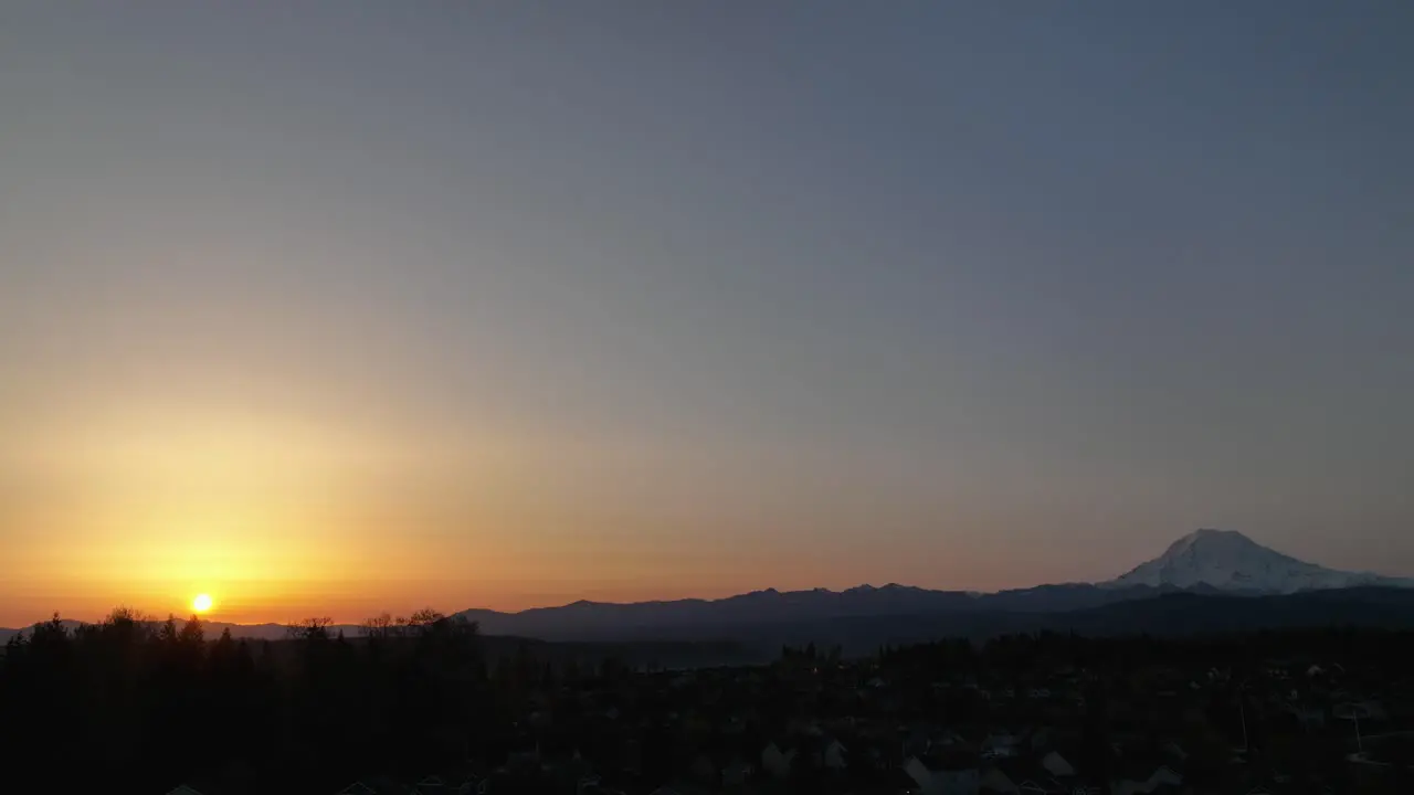 Rising aerial of the sunrise near a mountain