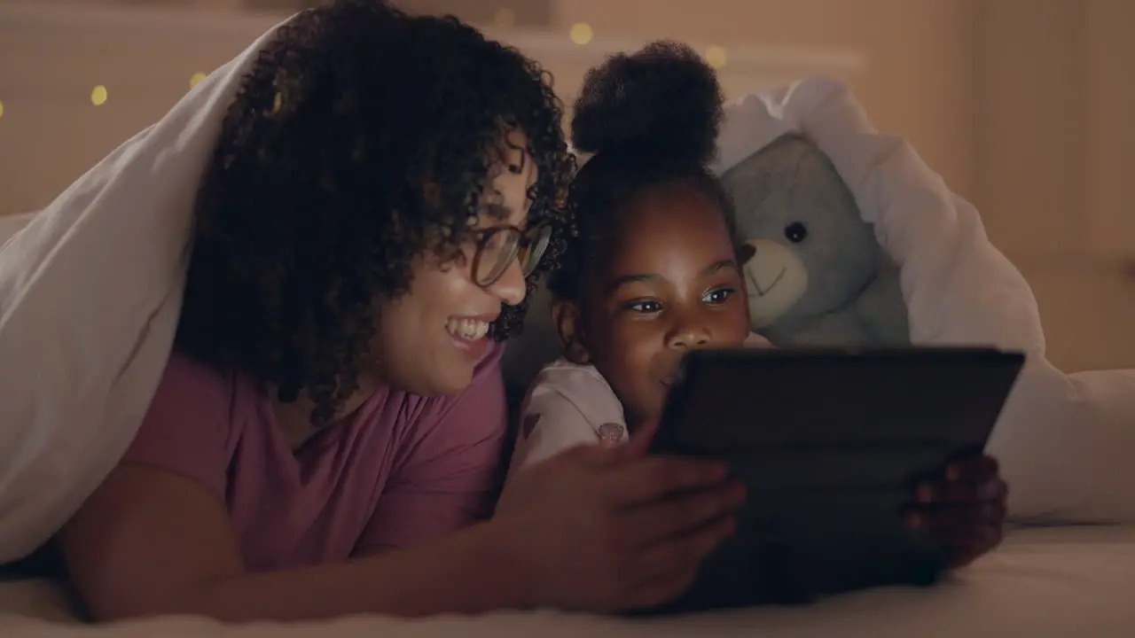 Mother girl and tablet in bed