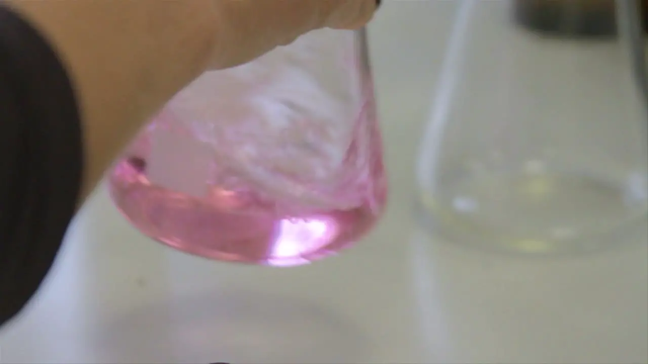 Scientist Pouring Sample Into Beaker