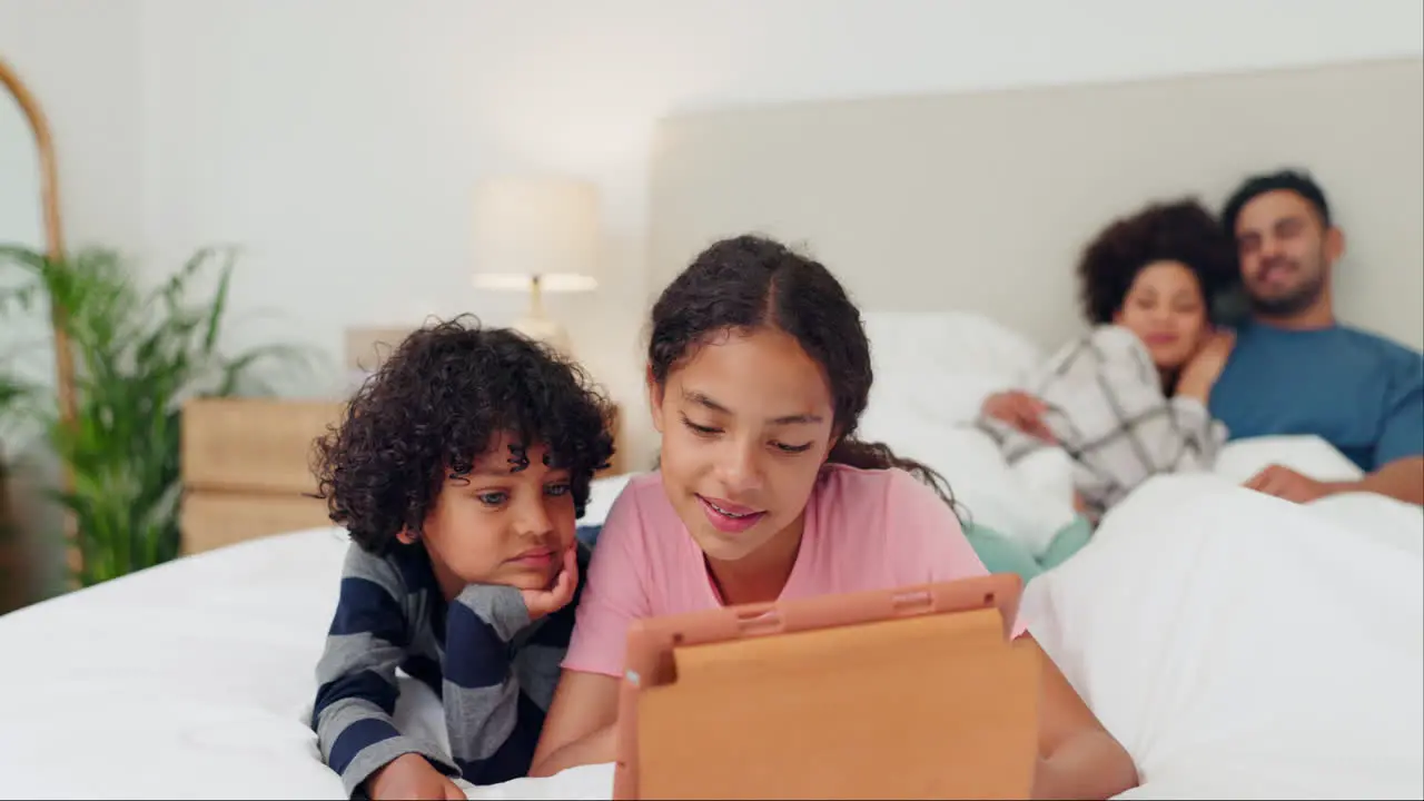 Happy family tablet and kids on a bed with love