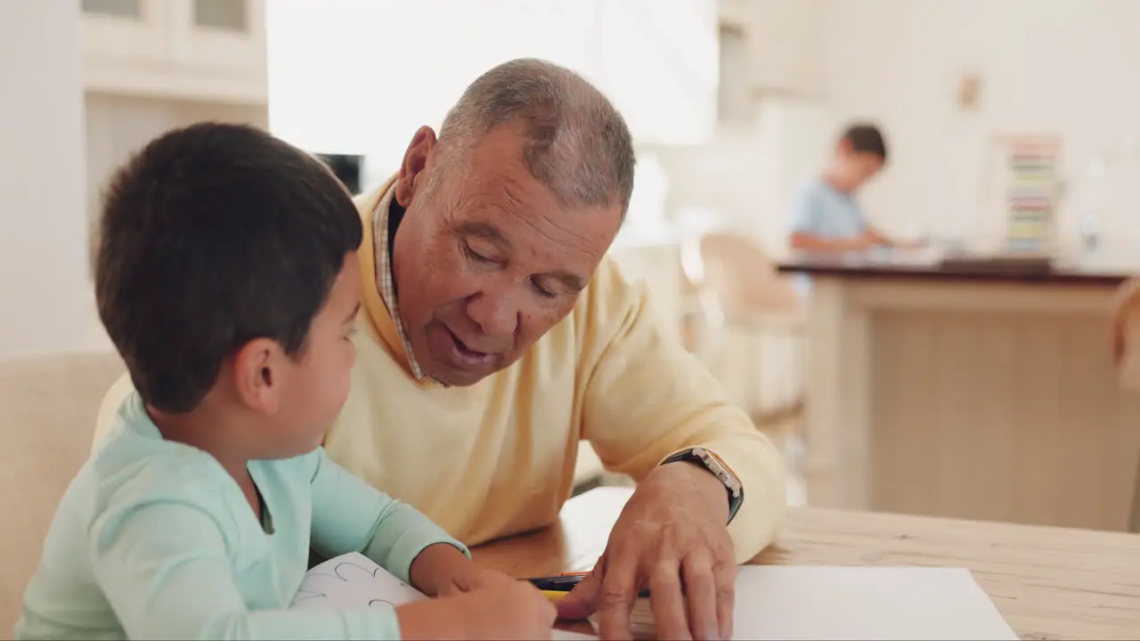 Grandfather talking or child drawing in books