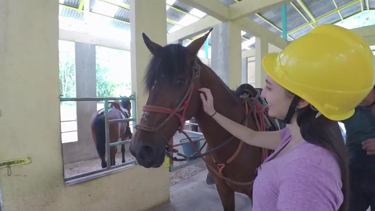 Girl Smiles While She Pets Horse With Instructor