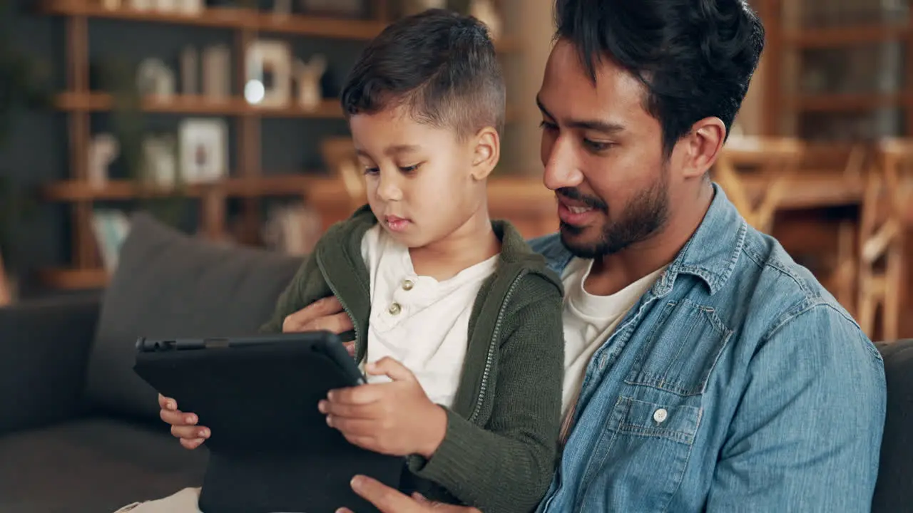 Tablet learning and father with child on sofa