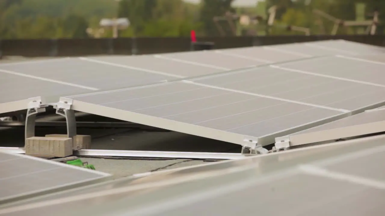 Close-up panning shot of solar panels on a rooftop with soft lighting