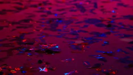 Close Up Of Sparkling Confetti On Floor Of Nightclub Bar Or Disco With Flashing Strobe Lighting 1