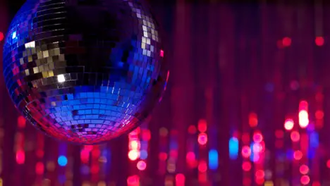 Close Up Of Mirrorball In Night Club Or Disco With Sparkling Lights In Background