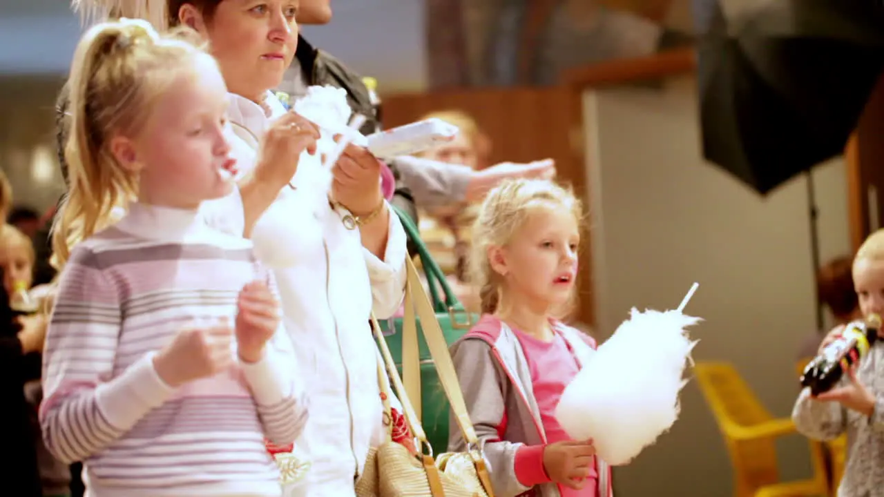 Two girls are eating white cotton candy