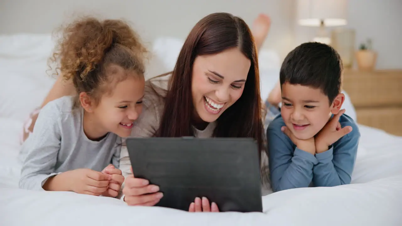 Tablet children and mother on bed with love