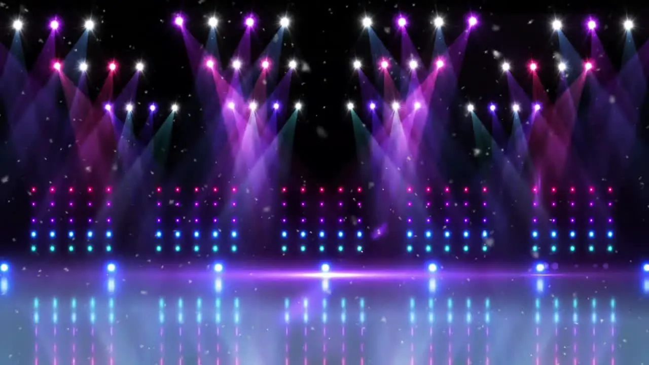 Animation of snow falling over purple and pink spotlights and banks of lights over empty stage