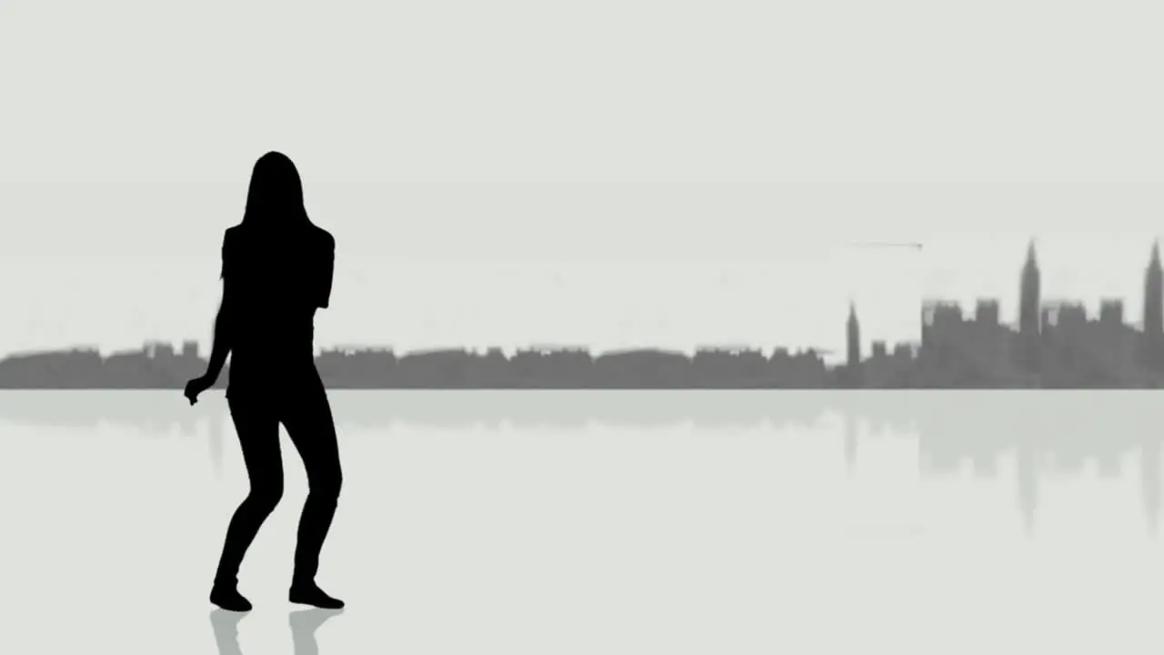 Woman dancing next to a screen