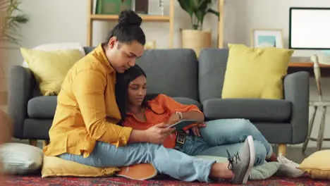 Happy couple together use a tablet on living room