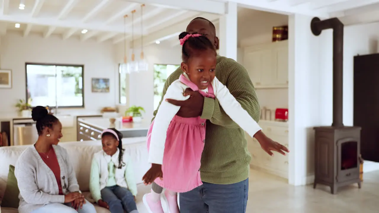 Black family happy and playing on a home sofa