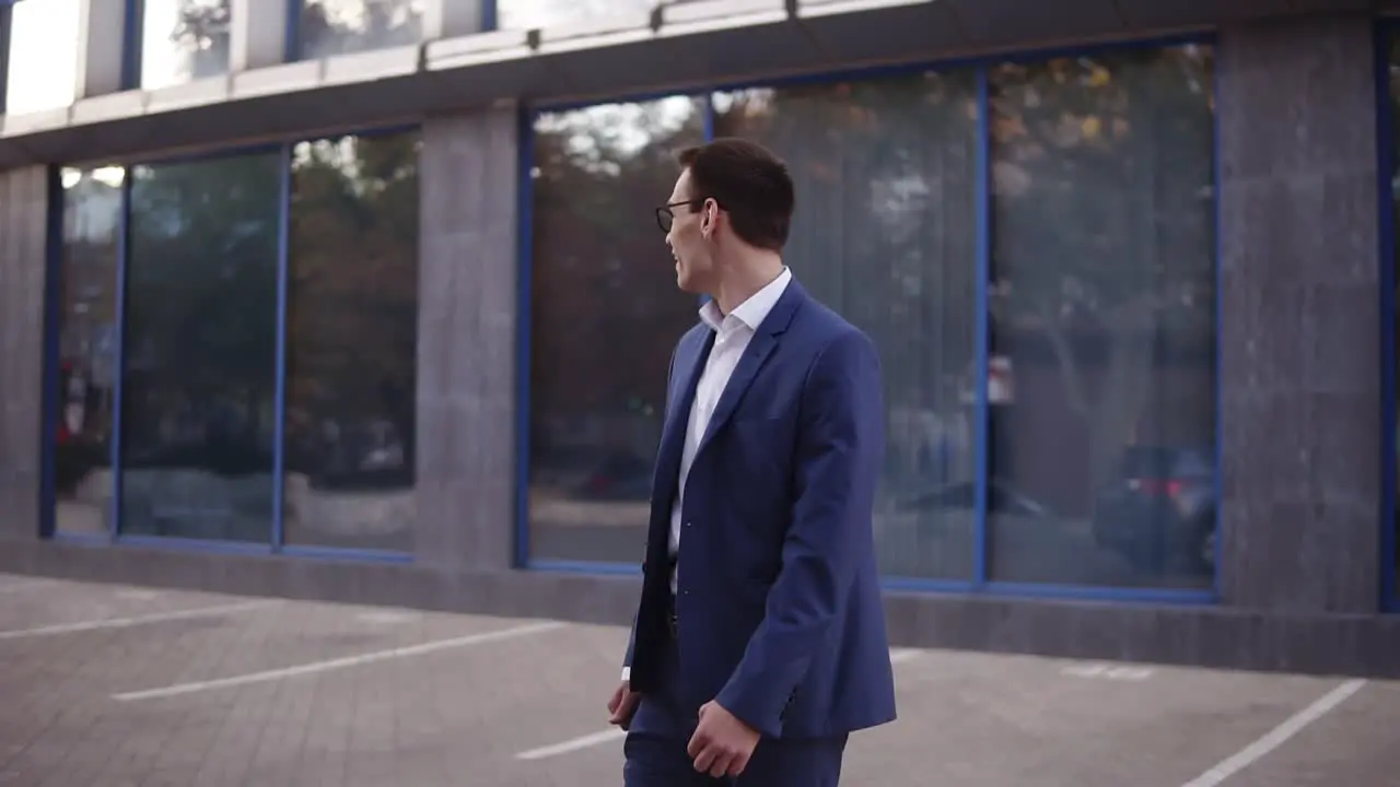 Young Businessman Looking Around To Sure Noone See Him And Starts To Express His Feeling About Victory And Big Success On The Street Near The Office Center Wearing Suit Celebrating His Achievements