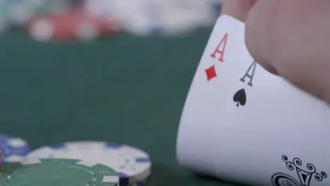 Extreme Close Up Shot of Poker Player Looking at Their Pocket Aces