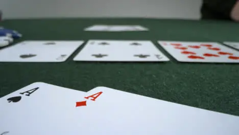 Sliding Extreme Close Up Shot of Poker Player Turning Over Pocket Aces