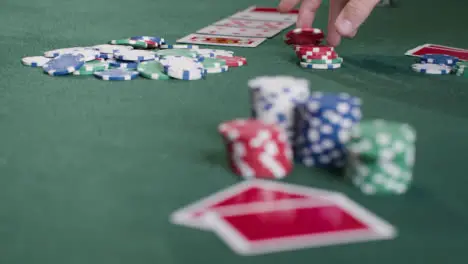 Wide Shot of Poker Player Checking Their Hand Before Betting