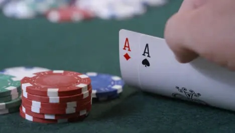 Extreme Close Up Shot of Poker Player Looking at Pocket Aces