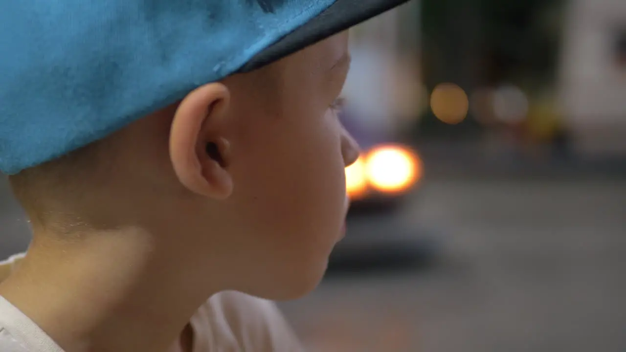 Child looking at bumper cars in amusement park