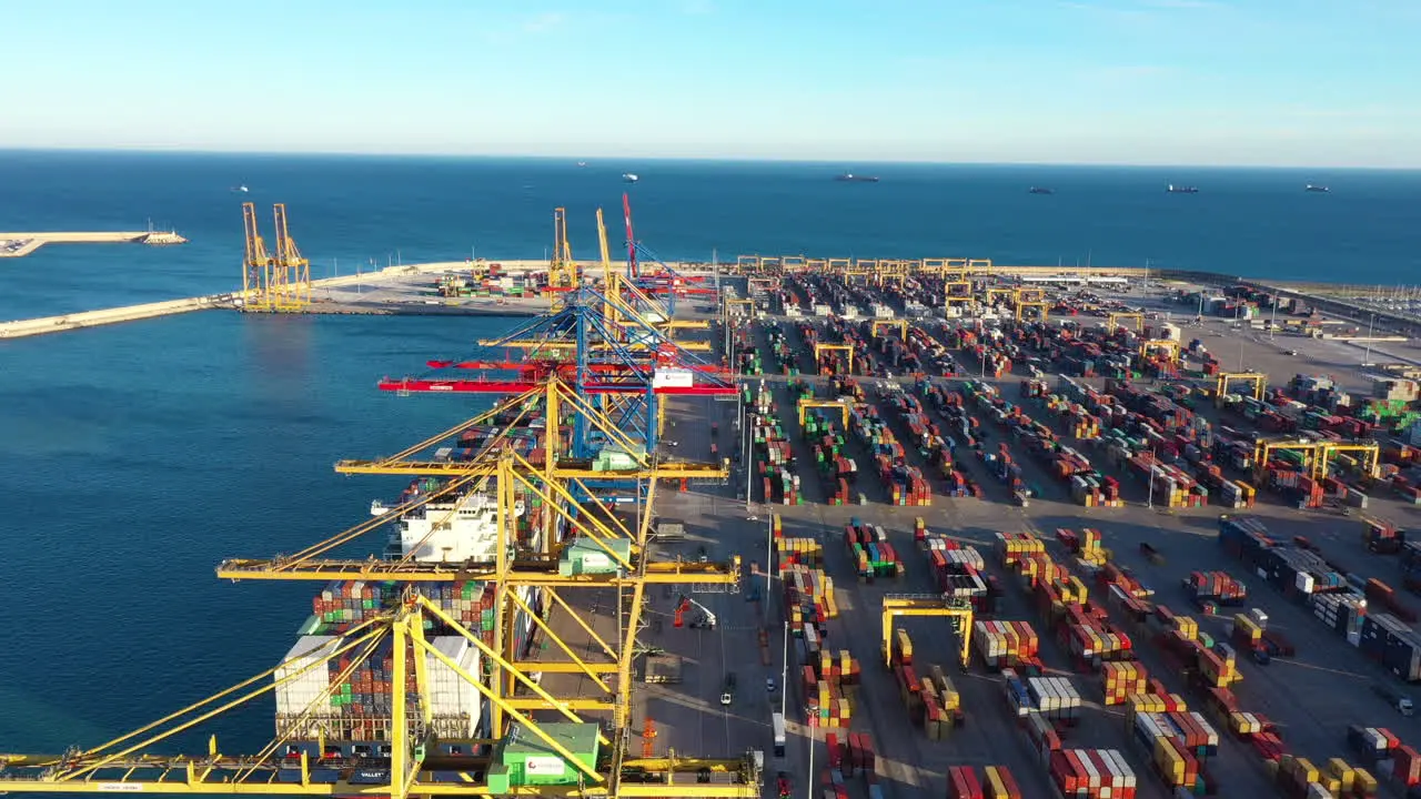 Port of Valencia cranes and containers Mediterranean sea aerial Spain sunset