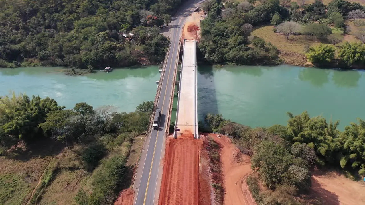 Aerial view of bridge in duplication phase on highway land transport vehicles trucks