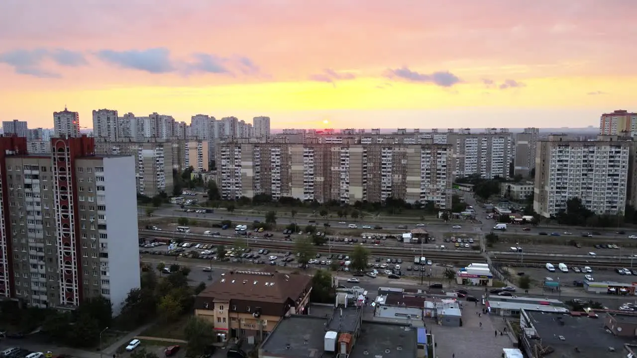 Aerial view of old buildings and the tramway rail system in Troieshchyna soviet district during sunset in Kiev Ukraine pan drone shot