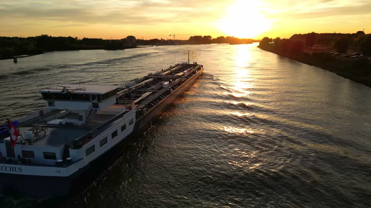 Zwijndrecht Netherlands 04 September 2022 Bacchus cargo ship sailing on Schelda river in Zwijndrecht Netherlands carrying containers at sunset