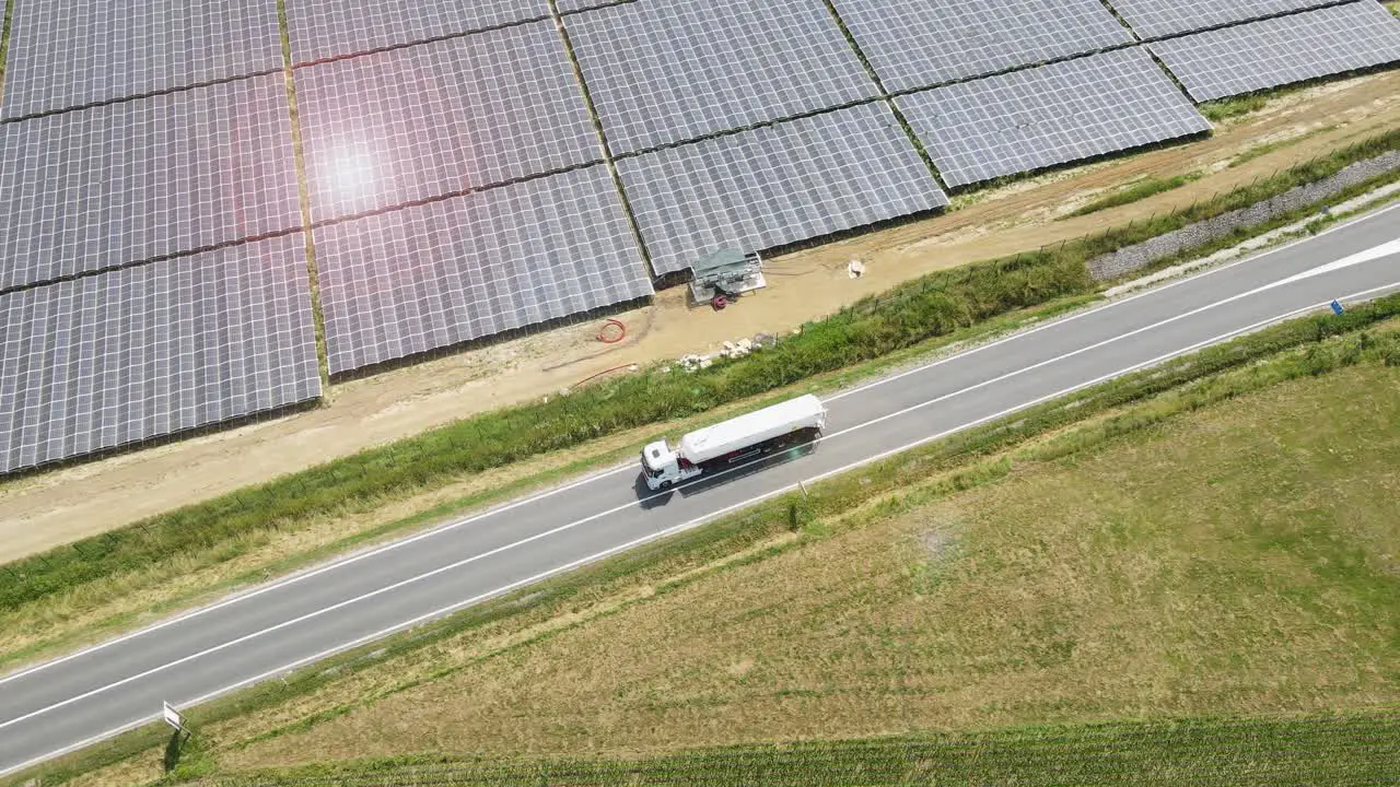 Truck Driving On The Highway Through Solar Farm