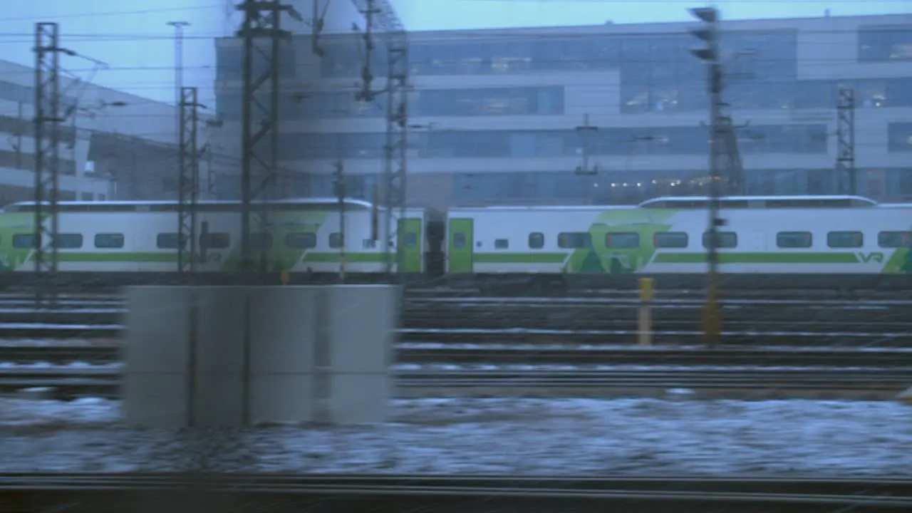 POV between two moving trains on urban multiline railway with zoom