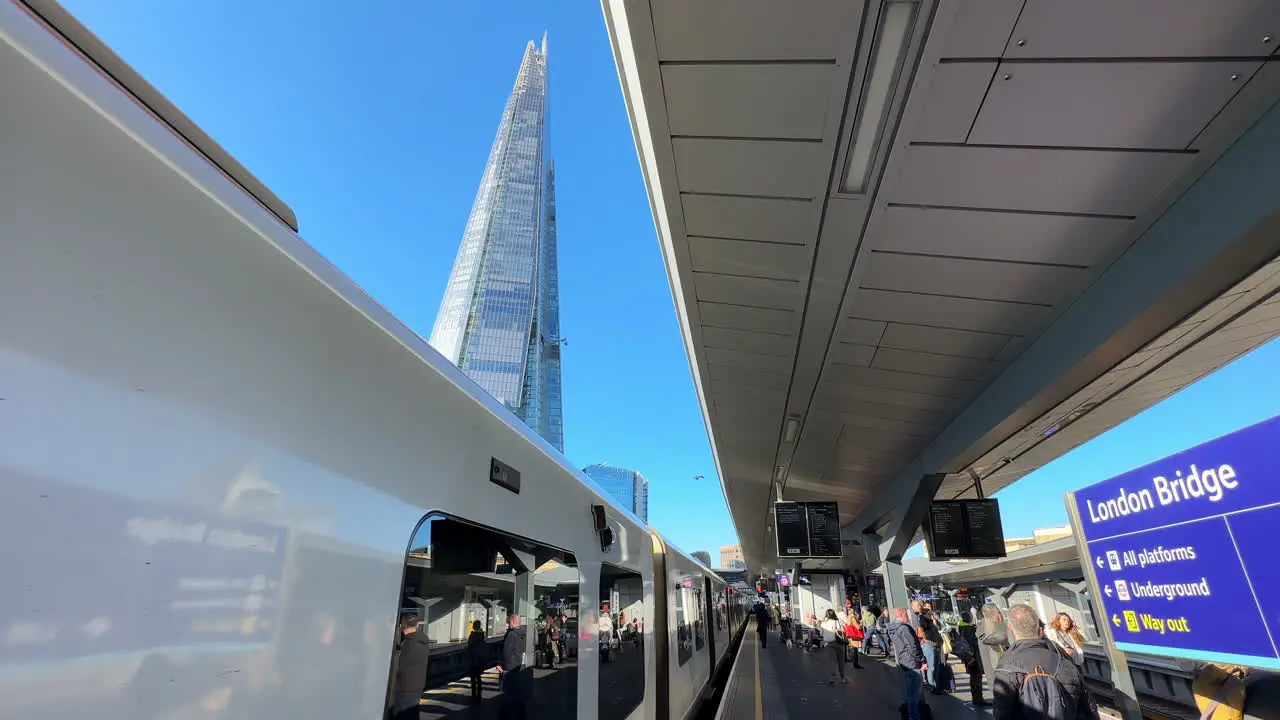 Train leaving London Bridge train station with The Shard skyscraper