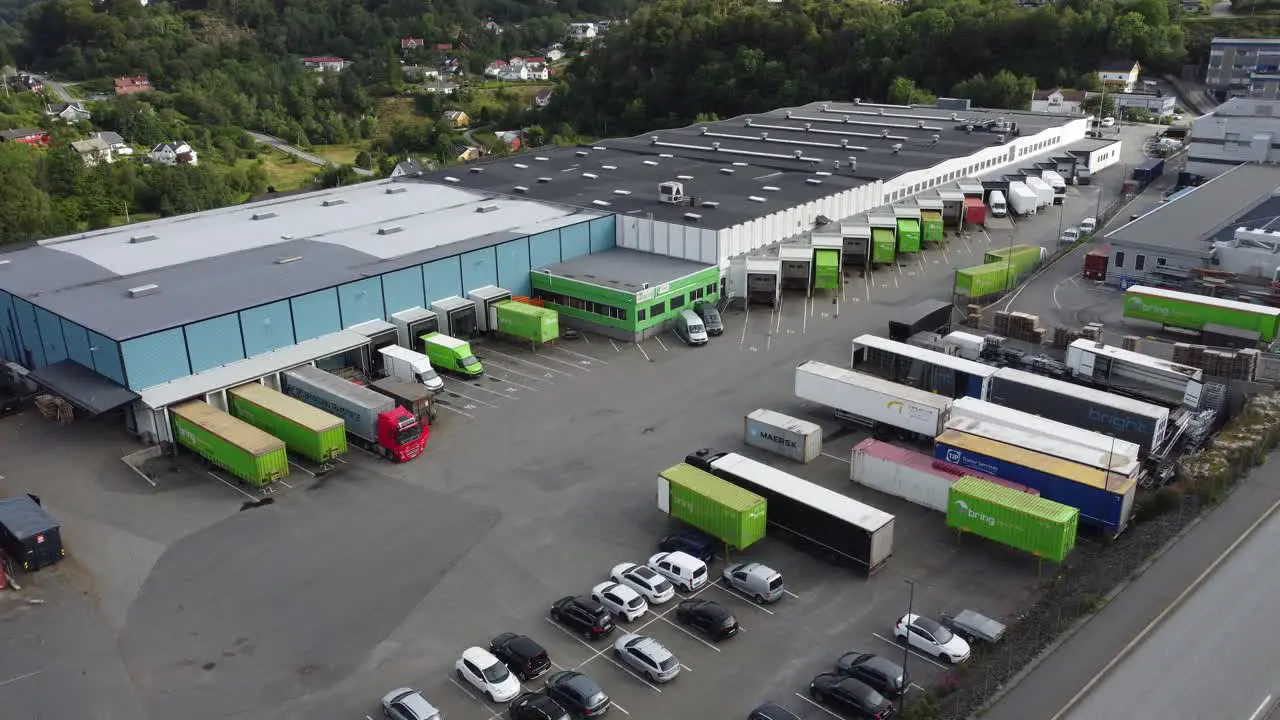 Posten Bring terminal in Nesttun outside Bergen Norway Aerial showing terminal building with many delivery trucks parked inside hub for loading and discharging goods