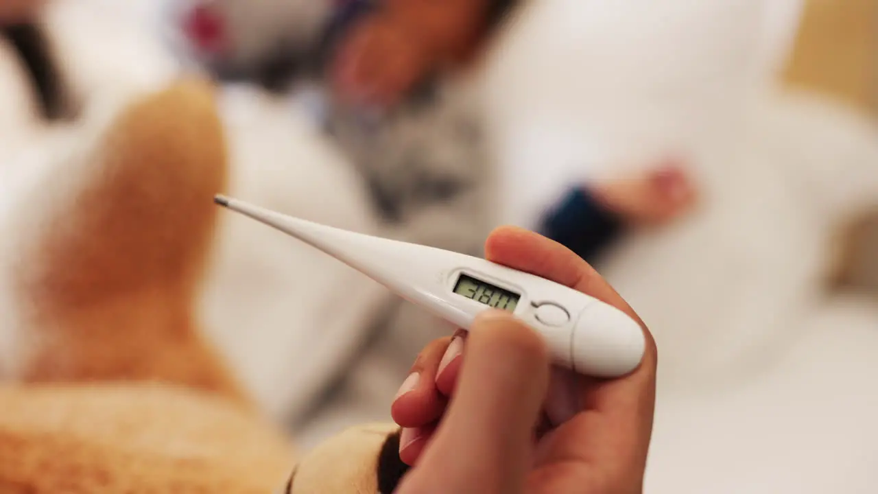 Hand thermometer and closeup for kid with fever