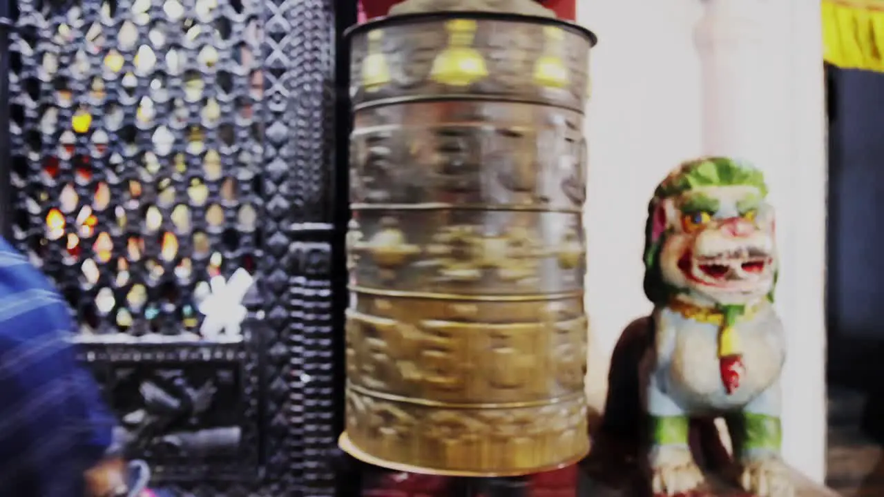 Frontal view of Asian locals spinning Buddhist prayer wheel hoping for luck and prosperity static