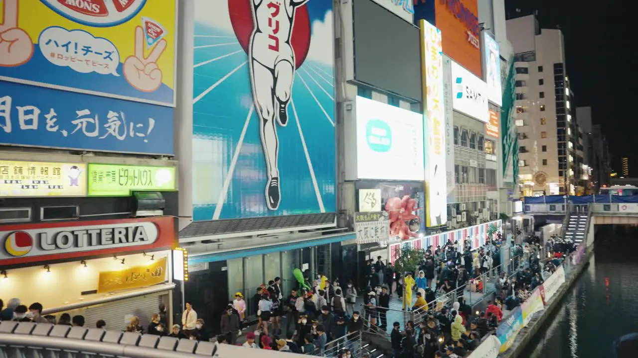 Osaka Ebisu Bridge and Glico Man Sign Crowds of Japanese Attending Halloween