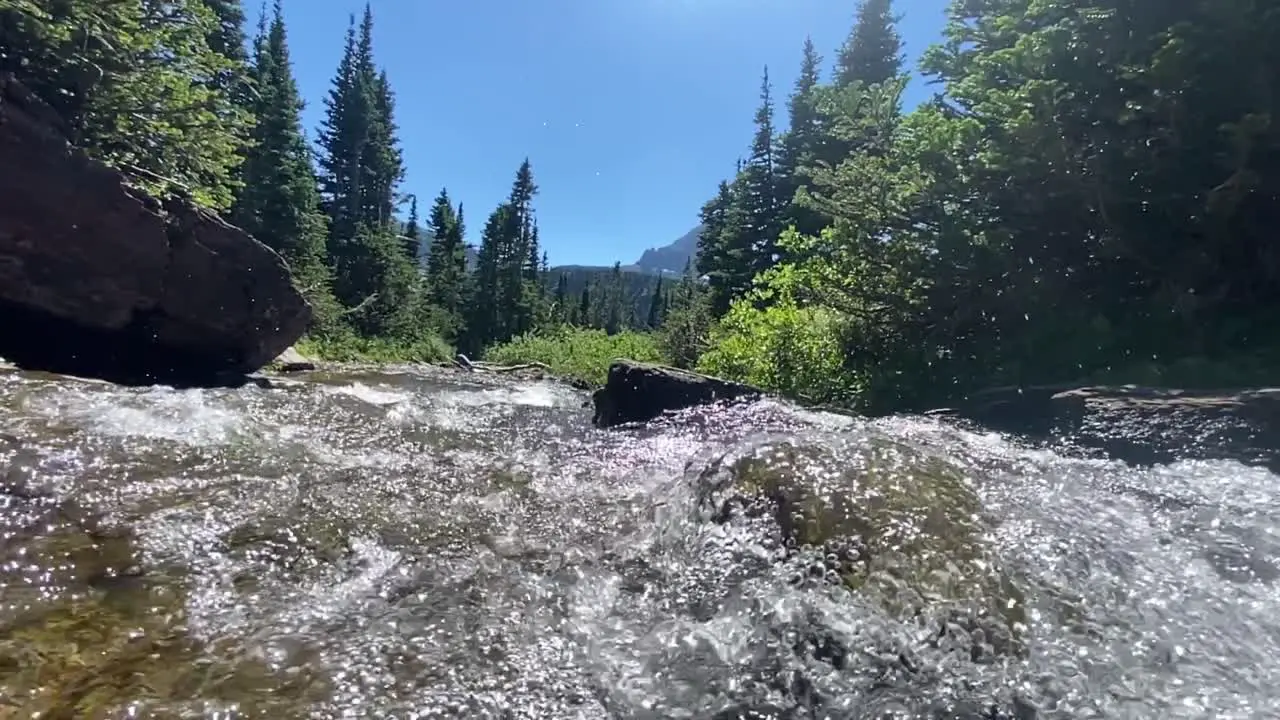 water flowing on a river in glacier national park during summer time