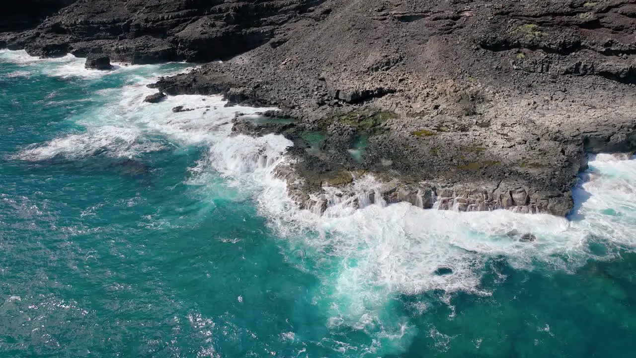 Hawaii's coast offers a captivating display of perilous beauty with towering white waves and distinctive volcanic rock