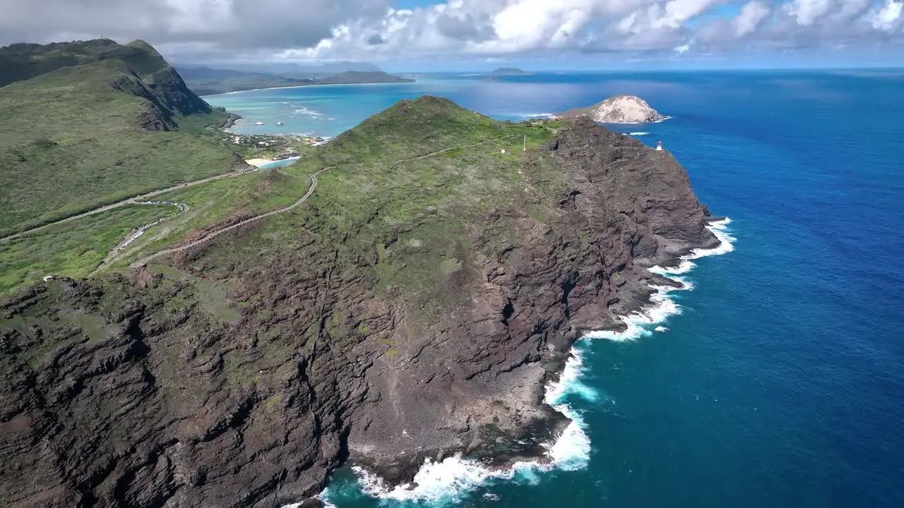 Hawaii's coastal landscape captivates with its perilous beauty featuring towering white waves and volcanic rock