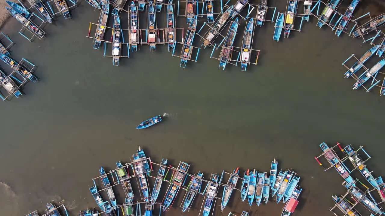 Aerial view of fishing boats lining the Cokel River in Pacitan Indonesia