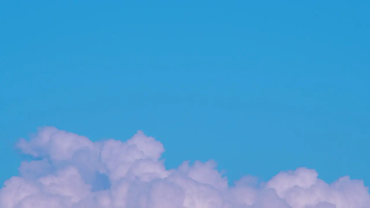 Time lapse of beautiful white fast moving fluffy clouds and sky in sunny day medium shot