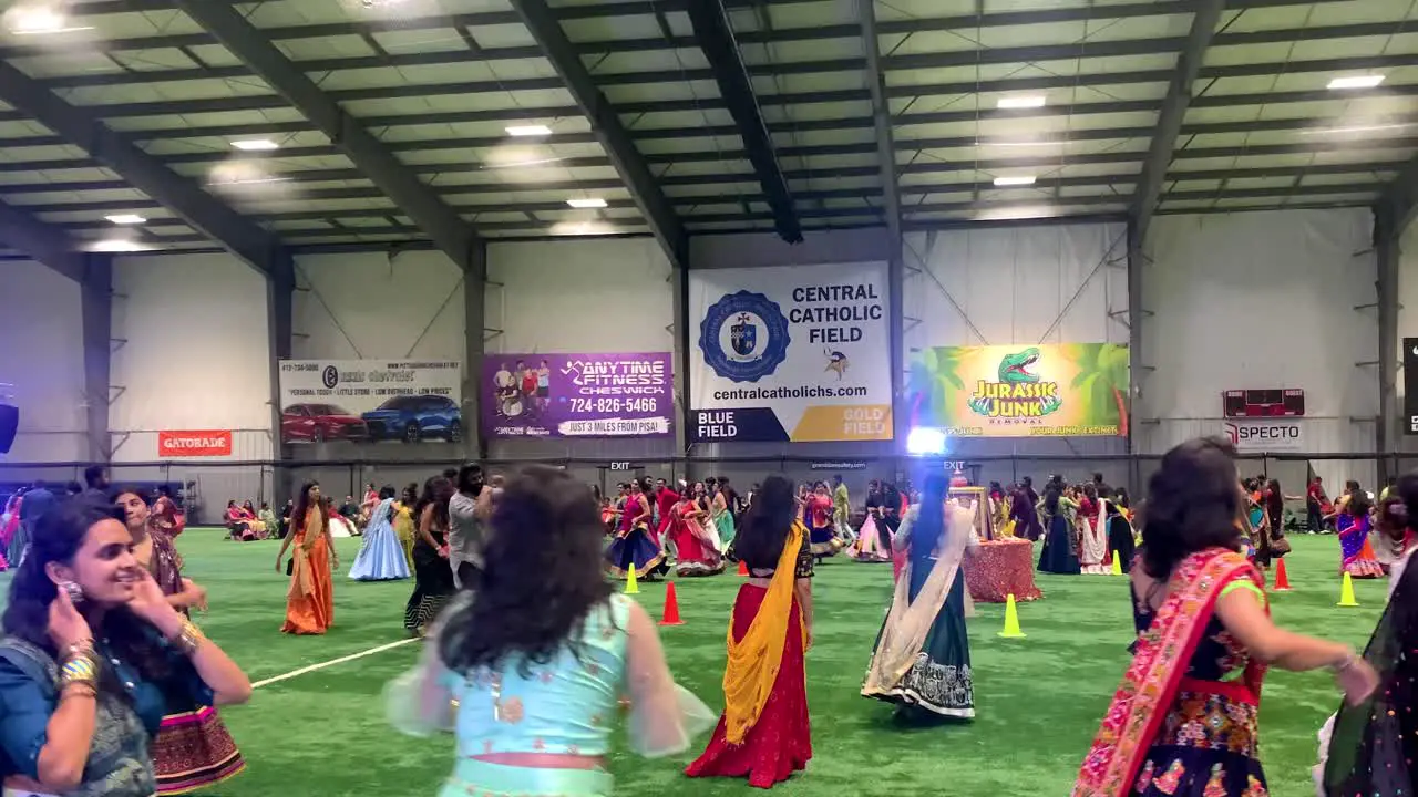 Group of Indian men and women playing Garba in traditional clothing