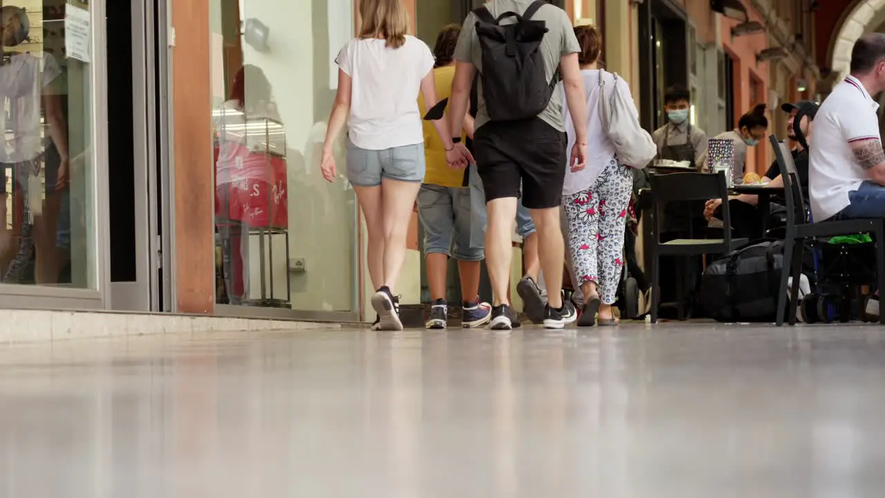 Tourists walking away from camera in slow motion scene low angle shot