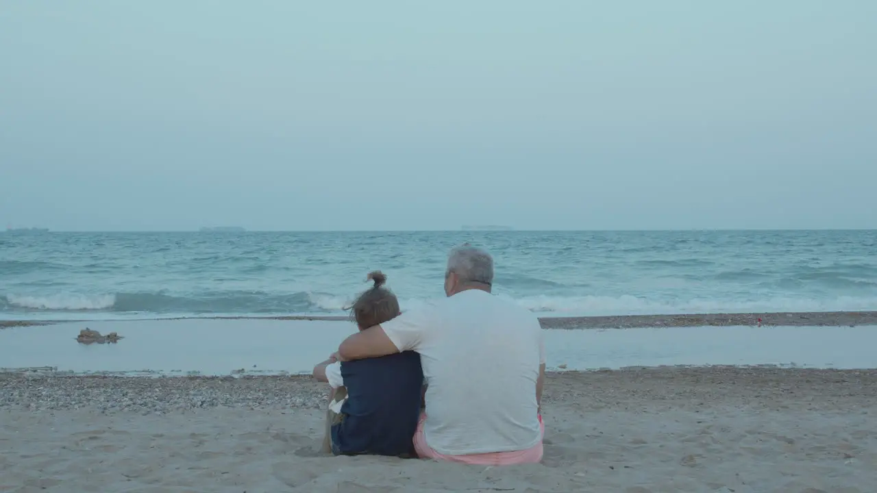 Boy enjoys being in grandpa hugs