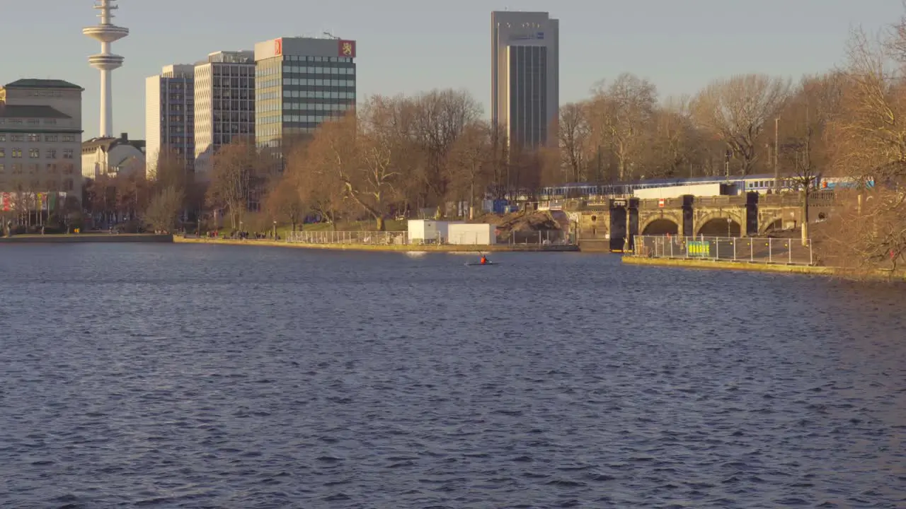 A kayaker paddling across Inner Alster Lake in Hamburg Germany in Dec 2019